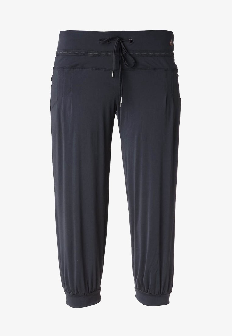 Pantalon de sport noir coupé court avec taille à cordon, poches latérales et poignets élastiques. Petit logo Adidas près de la ceinture.
