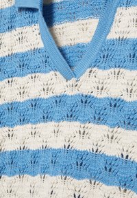 Gilet tricoté à rayures bleues et blanches avec un col en V et un motif ajouré texturé sur toute la surface.