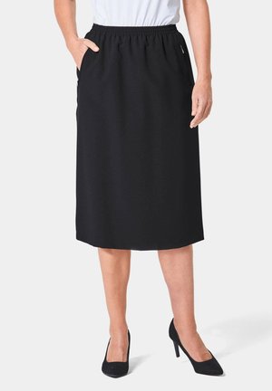 Zwarte knie-lange rok van zachte stof met een elastische tailleband en zijzakken, met een eenvoudig, gestroomlijnd ontwerp.