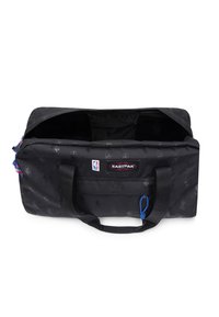 Czarna torba podróżna Eastpak z logo NBA, otwarta u góry, pokazująca wnętrze, czarne uchwyty i niebieski sznurek do zamka.