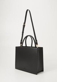 Black leather handbag with a structured rectangular shape, dual top handles, and an adjustable shoulder strap. Features gold hardware accents.