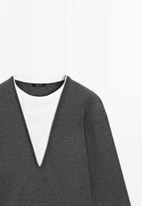 Gray deep V-neck sweater layered over white crew neck shirt, displayed against a plain white background.