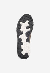 Semelle extérieure de chaussure de trail avec base en caoutchouc présentant des motifs contrastés noirs et blancs ; crampons profonds pour la traction et la durabilité.