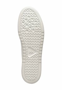 White rubber shoe sole with a textured zigzag pattern, circular grip points, and a triangle logo. Features raised edges and grooves for traction.