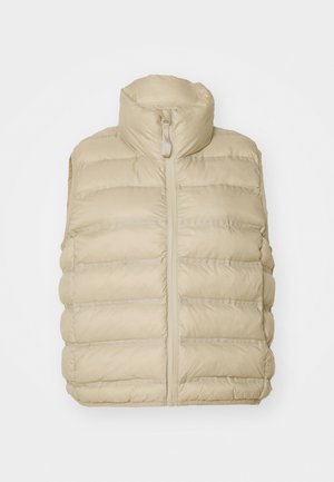 Beige puffer vest with high collar, front zipper, and horizontal quilted pattern. Soft, lightweight fabric with minimal detailing.