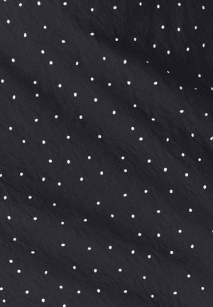 Black fabric with a crinkled texture, featuring evenly spaced white polka dots throughout the surface.