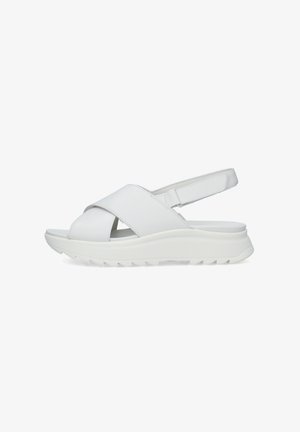 Sandalia blanca con suela acolchada, tiras anchas cruzadas y correa trasera ajustable con cierre de velcro, diseñada para comodidad y uso casual.