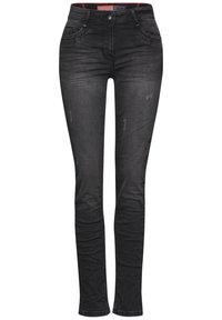 Jeans de denim negro con corte slim, que cuentan con cinco bolsillos, un ligero desgaste y una textura suave. Se cierran con un botón frontal y cremallera.