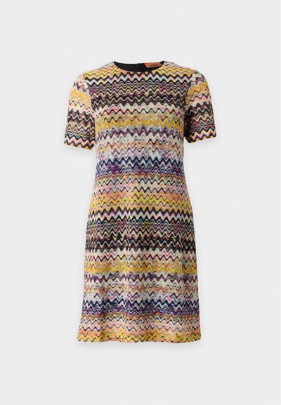 Robe à manches courtes avec motif zigzag multicolore en jaune, noir, rose, bleu et blanc sur fond clair.