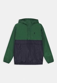 Grön och marinblå anorakjacka med huva, med halvlång dragkedja framtill, två sidofickor och en logga på bröstet. Tillverkad i lätt material.