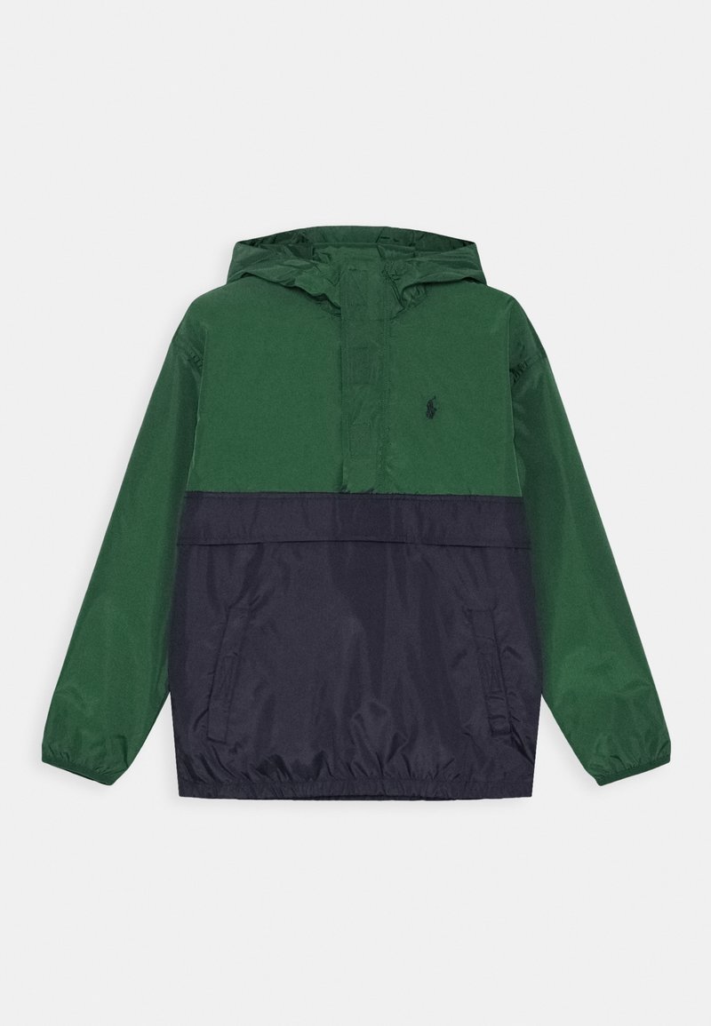 Grön och marinblå anorakjacka med huva, med halvlång dragkedja framtill, två sidofickor och en logga på bröstet. Tillverkad i lätt material.