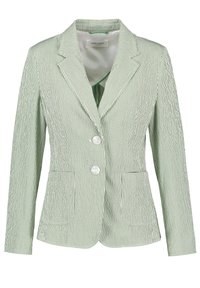 Blazer à rayures vertes et blanches en tissu léger, avec un col à revers, deux boutons et deux poches frontales.