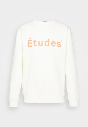 Weißes Langarm-Sweatshirt mit pfirsichfarbenem "Études"-Schriftzug auf der Brust, mit gerippten Bündchen und Saum.