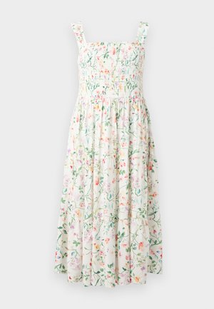 Robe blanche sans manches avec corsage smocké et jupe à volants, avec un imprimé floral multicolore et de fines bretelles.