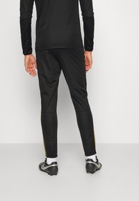 Nike Performance M NK DRY ACD21 TRK SUIT K - Fato de treino - black/laser orange