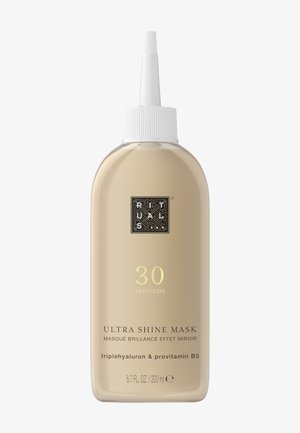 Bouteille transparente de 200 ml de Ultra Shine Mask avec un embout effilé, de couleur beige, étiquetage noir et or, et un capuchon texturé blanc.