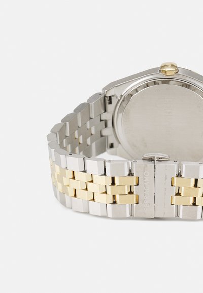Silver and gold stainless steel watch with a hexagonal case, featuring a two-tone metal bracelet and clasp, detailing engraved hardware.