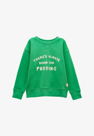 Žalia ilgomis rankovėmis sportinė palaidinė su briaunotais rankogaliais ir apykakle, ant krūtinės baltomis raidėmis užrašyta frazė „THERE'S ALWAYS ROOM FOR PUDDING“.