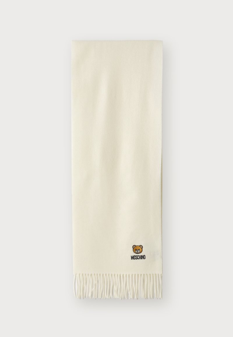 Sciarpa color crema realizzata in morbido tessuto, con bordi frangiati e un piccolo logo di un orsetto ricamato con testo "Moschino".