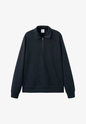 Tamno plava pulover majica s četvrtastim patentnim zatvaračem na ovratniku, dugim rukavima i rebrastim manžetama. Izrađena od mekanog materijala s glatkom teksturom.