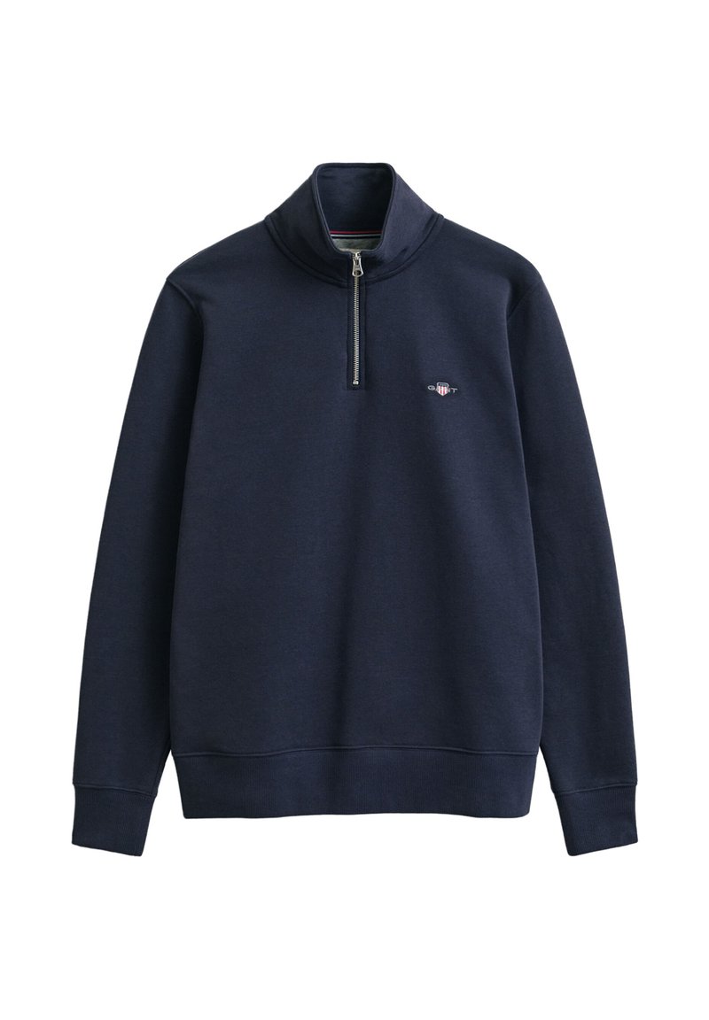 Marineblauer Pullover mit hohem Kragen, halbem Reißverschluss und gerippten Bündchen. Verfügt über ein kleines Logo auf der Brust. Weiche Stoffstruktur.