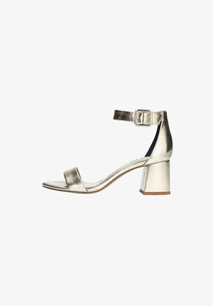 Metallic silver heeled sandal with a wide strap across the toe, adjustable ankle strap with buckle, and a square block heel. Smooth texture.