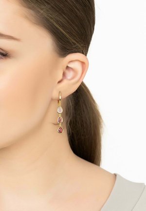 Gold hoop earrings with three teardrop-shaped gems—pink, lavender, and red—hanging vertically, showcasing smooth surfaces and vibrant colors.