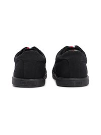 Black canvas sneakers with a low-top design, featuring a textured rubber sole and a small logo on the heel. Minimalist style with no embellishments.