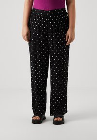 Vero Moda Curve VMCBUMPY WIDE - Trousers - black/white