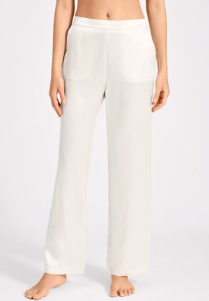 Pantalons larges couleur beige clair en tissu lisse et brillant. Dotés d'une taille élastique et de poches latérales. Design longueur sol.
