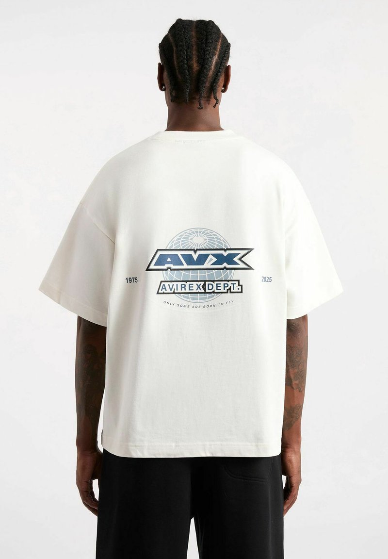 Camiseta blanca de gran tamaño con un logo de globo impreso y texto en la parte de atrás. Material de algodón suave con mangas cortas y un ajuste relajado.