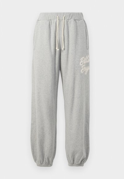 Grijze joggingbroek gemaakt van zacht materiaal, met een trekkoord in de taille, elastische boordjes, zijzakken en het 'Billabong' logo in lichte borduursel.