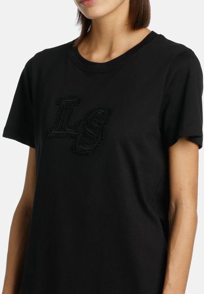Black cotton t-shirt featuring a textured black "LS" logo on the front, short sleeves, and a round neckline with a relaxed fit.