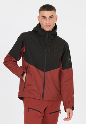 Red and black waterproof jacket with a hood, featuring zippered pockets, elastic cuffs, and a geometric color block design.
