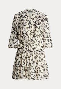 Blommig klänning i krämfärgad med svart bladmönster, med volangkrage, långa ärmar och lager på lager nertill. Tillverkad av lättviktsmaterial.