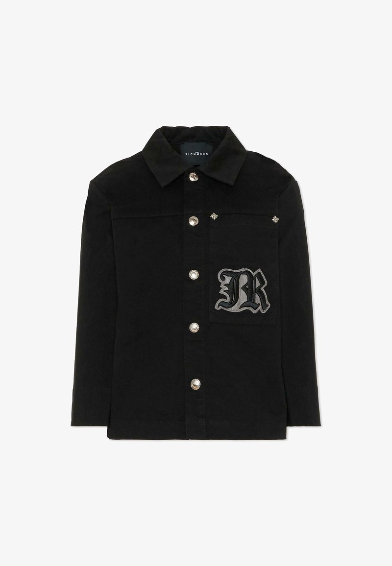 Zwarte shirtjack met een puntige kraag, zilveren knopen, geborduurd "R"-patch en decoratieve accenten op de schouders.