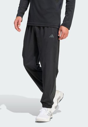 TECHESS - Tracksuit bottoms - black
