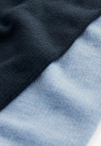 Tessuto di cotone in blu scuro e azzurro chiaro, caratterizzato da una morbida texture spazzolata con una transizione fluida tra i due colori.