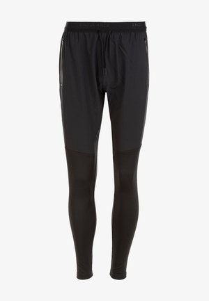 Schwarze sportliche Hosen mit schmaler Passform, ausgestattet mit einem strukturierten oberen Stoff und glatten Unterschenkeln, elastischem Bündchen und verstellbarem Kordelzug.