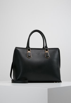 Black leather handbag with dual top handles, gold-tone hardware accents, and a detachable shoulder strap. Smooth texture and structured design.