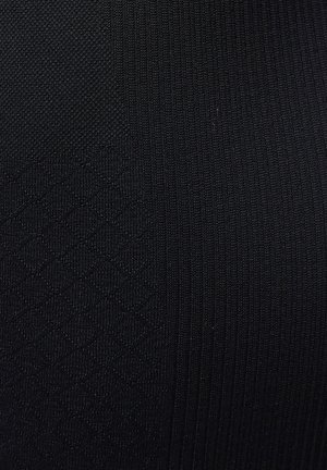 Black fabric featuring a textured pattern with raised diamond shapes and vertical ribbing, showcasing a uniform color and smooth surface.
