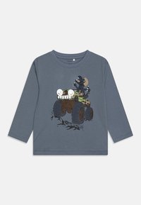 Long-sleeve grey cotton t-shirt featuring a graphic of a monster truck and a character with exaggerated eyes, set against a light background.