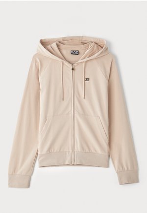 Fleece bege com fecho e capuz. Possui mangas raglan, bolsos frontais e um pequeno logótipo no peito. Tecido suave e macio com punhos elásticos.