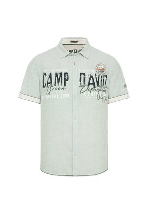 Cămașă cu mânecă scurtă, cu nasturi, dintr-un material verde deschis, având un model în dungi și text imprimat. Guler și manșete accentuate cu detalii de logo.