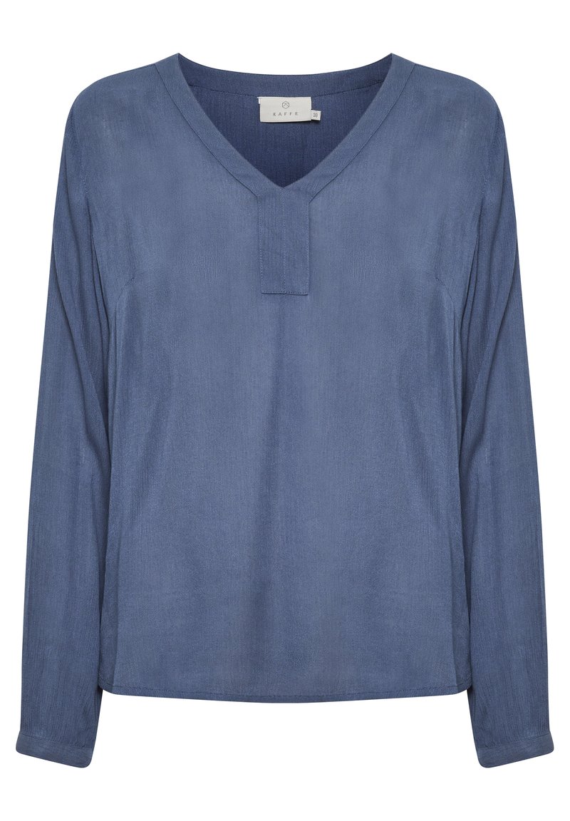 Mėlyna ilgomis rankovėmis bluzonai su V formos iškirpte. Pagaminta iš lygios medžiagos, turi mažą apykaklę ir laisvą siluetą. Nėra matomų raštų ar detalių.