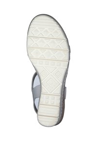 Witte sandaalzool met gestructureerd rubber met geometrische patronen, waaronder diamanten en vierkanten, en een gemusterd rand langs de randen.