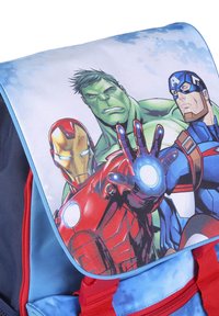 Blue backpack with red accents features a colorful graphic of Iron Man, Hulk, and Captain America on the flap, made from durable fabric.