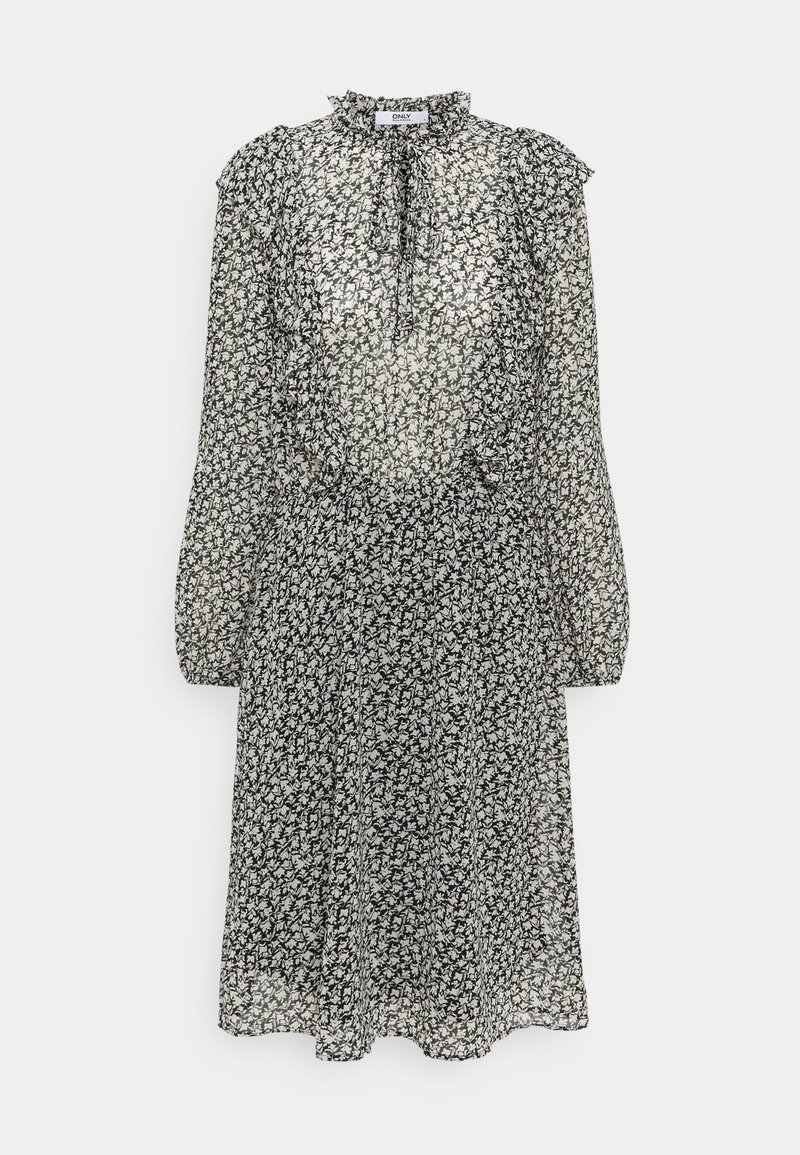 Robe midi imprimé floral noir et blanc avec manches longues bouffantes, col à volants et détail noué au niveau de l'encolure.
