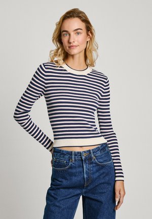 Pull en maille côtelée rayé dans des nuances de marine, crème et rose clair. Doté de manches longues, d'un col arrondi et d'une taille ajustée. Associé à un jean en denim à taille haute.