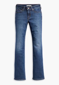 Jean bootcut en denim bleu avec bouton devant, fermeture éclair, style cinq poches et légère décoloration sur les cuisses et les genoux.